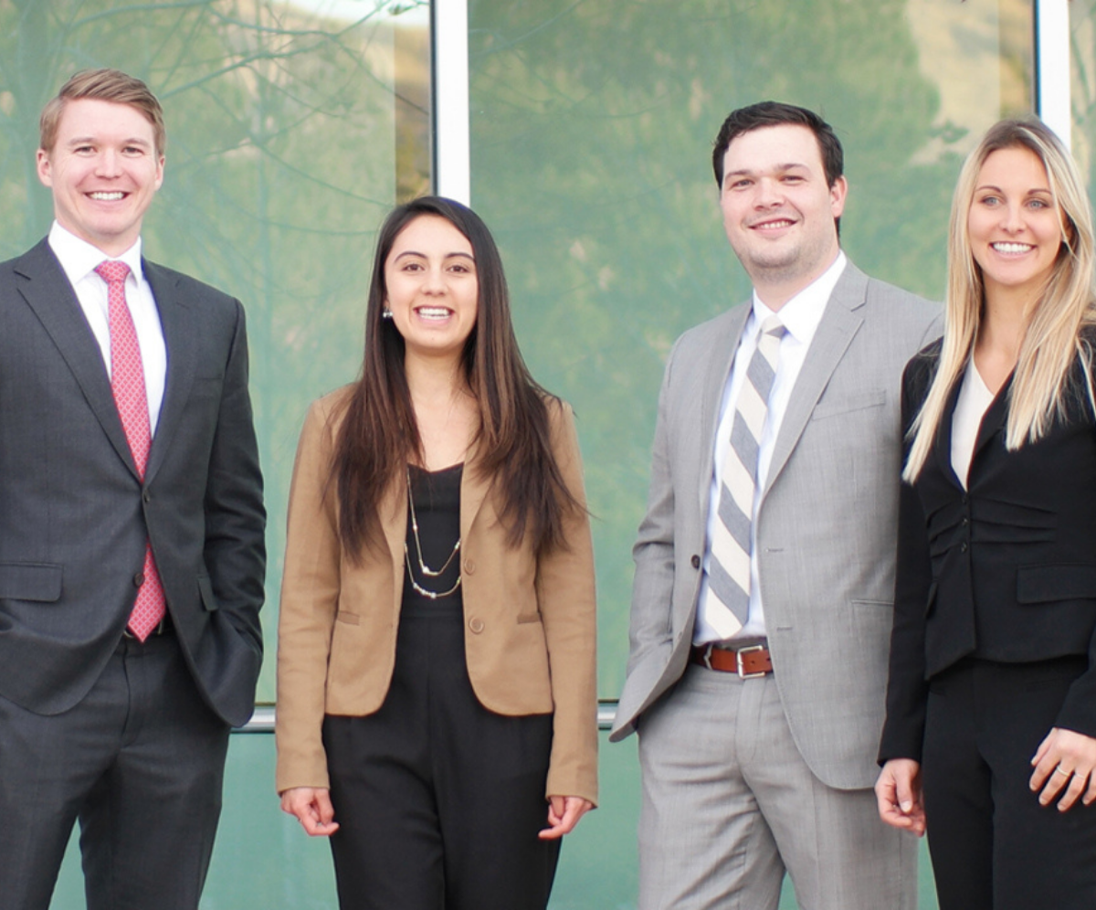 A group of professionally dressed finance students